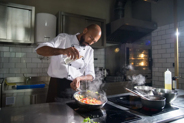 Sous chef preparing food in a professional kitchen