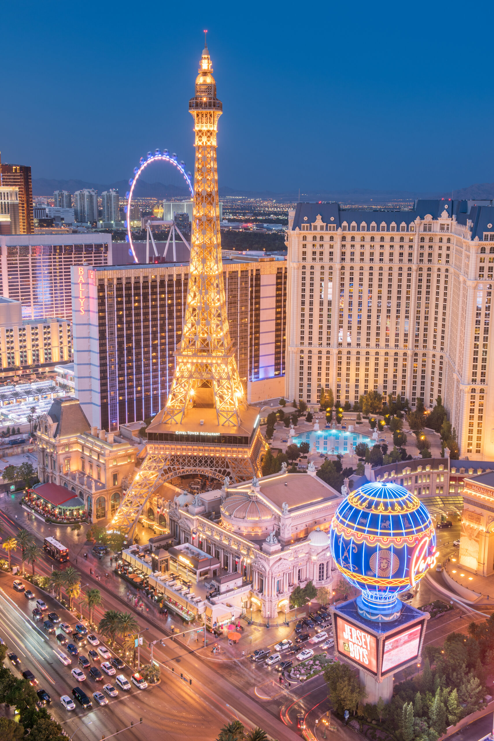 Las Vegas, Nevada, USA - September 12, 2015: Las Vegas Strip with moving traffic in front of the Paris Casino Hotel with the Ballys , Flamingos, the Wheel and Treasure Island Hotel in back.